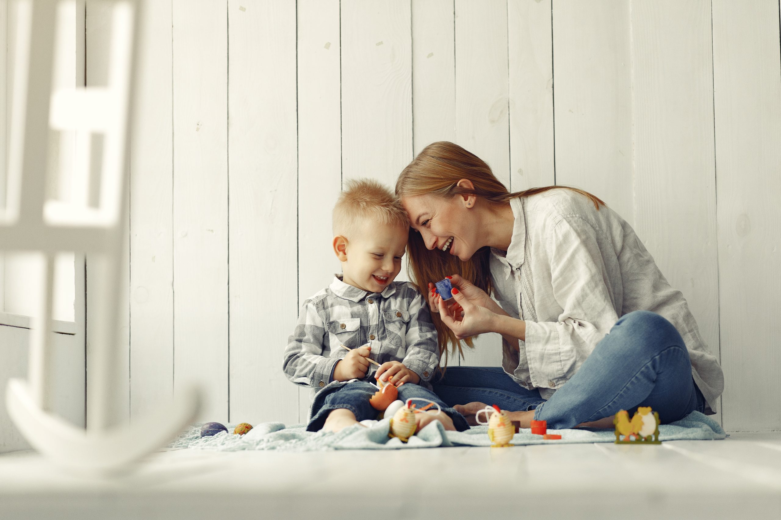 mother with son preparing easter home scaled
